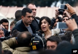 FILE - Former Islamic State captive Iraqi Yazidi Nadia Murad, center, speaks during a visit in a makeshift refugee camp at the northern Greek border point of Idomeni, Greece, April 3, 2016.