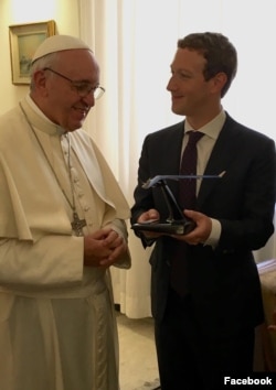 Facebook founder Mark Zuckerberg is seen handing the Pope a model of a Facebook drone.