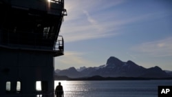 FILE - Personnel stand aboard the Finnish icebreaker MSV Nordica as it arrives into Nuuk, Greenland, after traversing the Northwest Passage through the Canadian Arctic Archipelago, July 29, 2017.