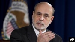 Federal Reserve Chairman Ben Bernanke gestures as he speaks during a news conference at the Federal Reserve Board in Washington, December 12, 2012.