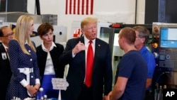 President Donald Trump participates in a tour of an advanced manufacturing lab with Ivanka Trump, second from left, and Gov. Kim Reynolds, R-Iowa, third from left, at Northeast Iowa Community College in Peosta, Iowa, July 26, 2018. 