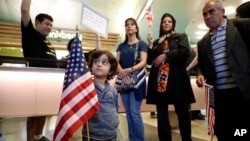 In this photo from Jan. 29, 2017, Shayan Ara, 3, holds an American flag at a protest against President Donald Trump's executive order banning travel from seven Muslim-majority countries at Los Angeles International Airport in California. 