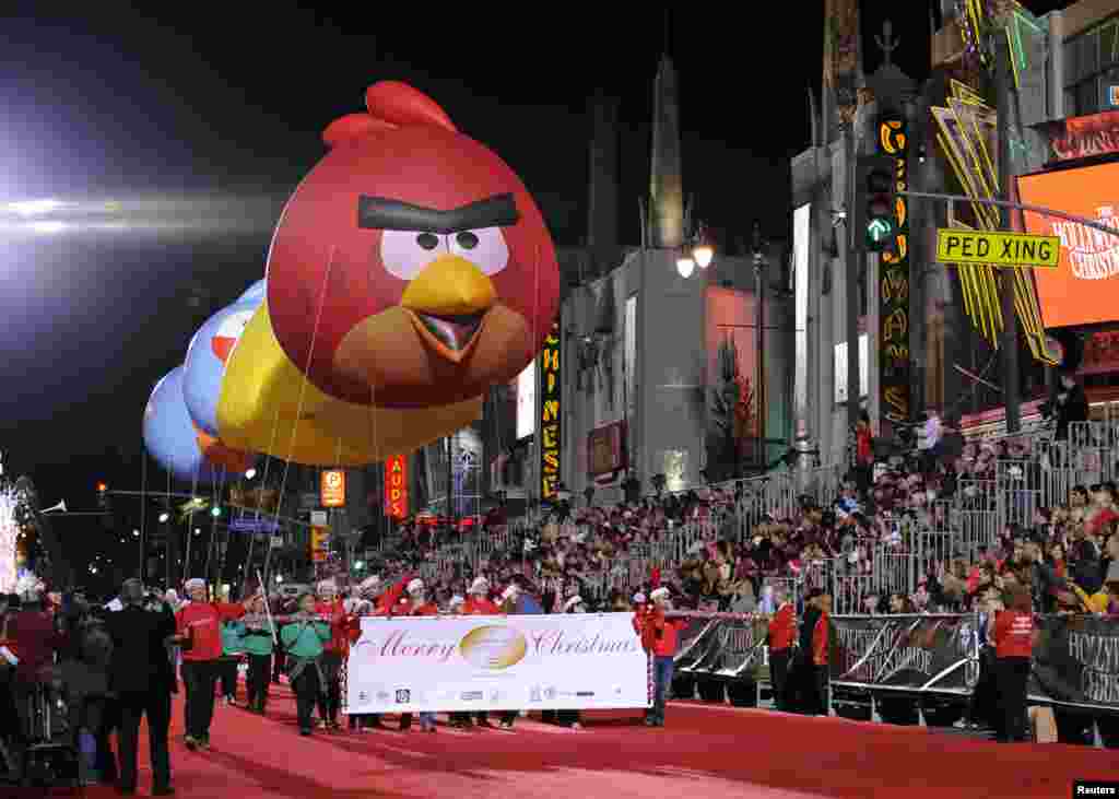 Large Angry Birds balloons are carried down Hollywood Boulevard during the 82nd Annual Hollywood Christmas Parade in Los Angeles, California, Dec. 1, 2013. 
