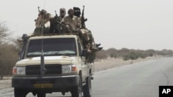 Chadian troops ride toward lake Chad near Bashoum, Chad, as large contingents of Chadian troops were seen heading the the region bordering Nigeria, March 6, 2015. 