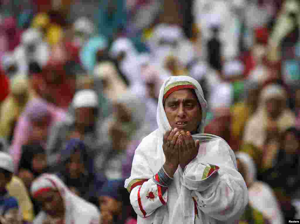 A Muslim woman prays after the last Friday prayers of the holy fasting month of Ramadan at the Jama Masjid (Grand Mosque) in the old quarters of Delhi, India.