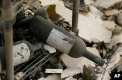 The remains of burned bottles of wine are seen at the Signorello Estate winery in Napa, Calif., Oct. 10, 2017.