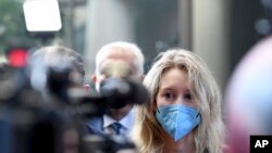 Elizabeth Holmes, founder and CEO of Theranos, arrives at the federal courthouse for jury selection in her trial, in San Jose, Calif. (AP Photo/Nic Coury)