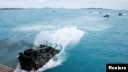 U.S. Marines assault amphibious vehicles, depart the well deck of the amphibious transport dock ship USS Green Bay, during the Talisman Sabre 2019, a U.S. and Australian biennial training event off the coast near Bowen, Australia on July 22, 2019.