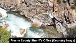 A helicopter searches a canyon where the car of a missing San Diego man and his wife was found. (Fresno County Sheriff's Office)