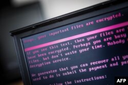 A laptop displays a message after being infected by ransomware as part of a worldwide cyberattack on June 27, 2017 in Geldrop, Netherlands.
