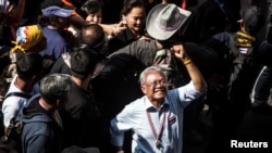 Protest leader Suthep Thaugsuban gestures as he leads anti-government protesters marching through Bangkok's financial district, Jan. 23, 2014.