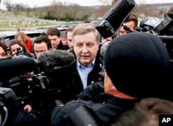 Republican Rick Saccone, center, is surrounded by cameras and reporters as he heads to the polling place to cast his ballot in McKeesport, Pennsylvania, March 13, 2018.