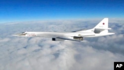 In this image made available by the Royal Air Force, Jan. 15, 2018, one of Russian Blackjack Tupolev Tu-160 long-range bombers is photographed by an RAF aircraft, scrambled from RAF Lossiemouth, Scotland.
