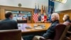 In this photo released by The White House, President Joe Biden, center, meets virtually with his national security team and senior officials to discuss Russia's aggressive actions toward Ukraine, Jan. 22, 2022, at Camp David, Md.