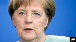 FILE - German Chancellor Angela Merkel addresses the media during a news conference at the chancellery in Berlin, Germany, June 7, 2016.