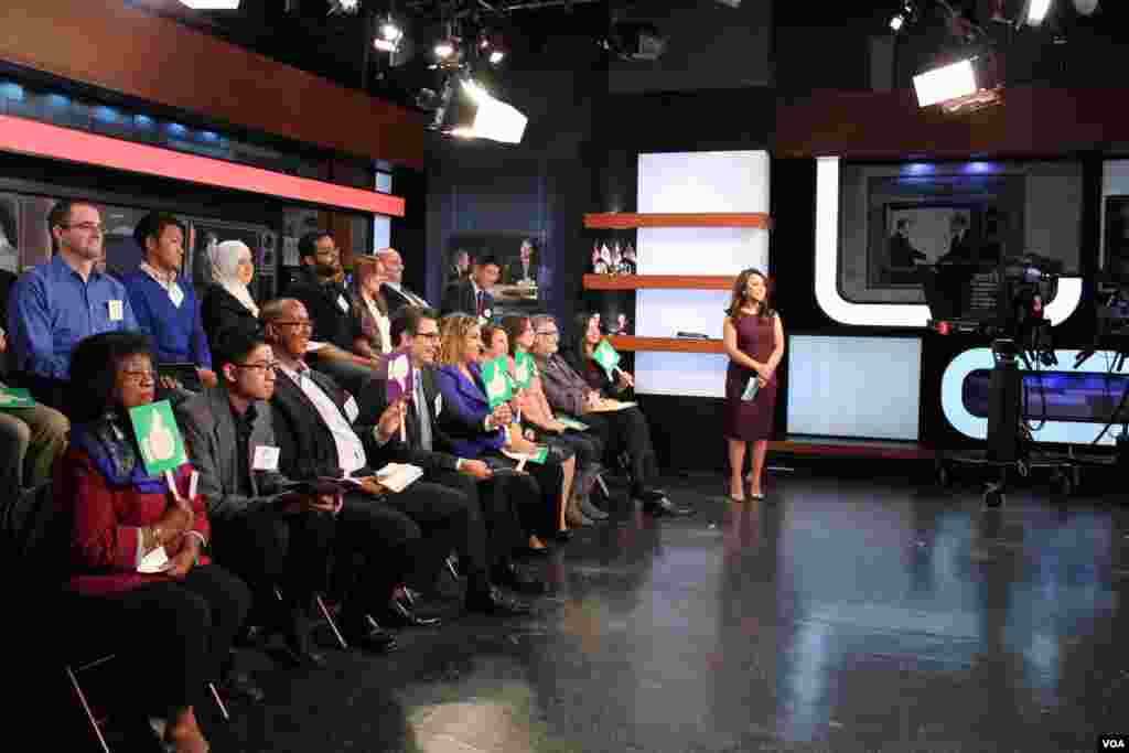 Participants watch the second presidential debate, October 9, 2016. 