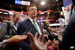 FILE - Trump Campaign Chairman Paul Manafort is surrounded by reporters on the floor of the Republican National Convention at Quicken Loans Arena in Cleveland, July 17, 2016.