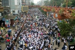 Bangladeshi students shout slogans and block a road during a protest in Dhaka, Bangladesh, Aug. 4, 2018. Days of protests by tens of thousands of students angry about the traffic deaths of two of their colleagues have largely cut off the capital, Dhaka.