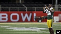 Green Bay Packers' Charlie Peprah takes a picture during media day for NFL football Super Bowl XLV in Arlington, Texas, February 1, 2011