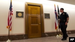 A U.S. Capitol Police officer walks past Sen. Roger Wicker's office in the Dirksen Senate Office Building on Capitol Hill, Washington, April 16, 2013.