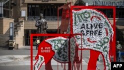 FILE - An installation showing a rhino and an elephant is seen in Mandela Square as part of the CITES (Convention on International Trade in Endangered Species of Wild Fauna and Flora) convention in Johannesburg, South Africa, Sept. 26, 2016. 