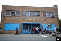 A vendor stands near his items outside the Integrity Masonic Temple in Paterson, N.J., Nov. 1, 2017.