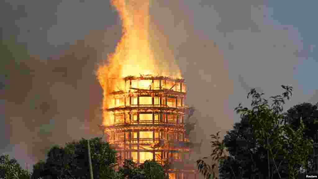 A temple under construction is seen engulfed in fire in Mianzhu, Sichuan province, China, Dec. 10, 2017.