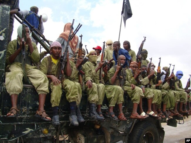 FILE - Al-Shabab fighters sit on a truck as they patrol in Mogadishu, Somalia,Oct. 30, 2009.