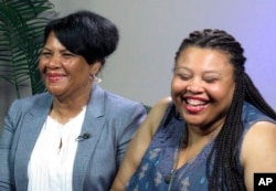 FILE -- Alice Marie Johnson, left, and her daughter Katina Marie Scales wait to start a TV interview, June 7, 2018, in Memphis, Tennessee. Johnson, convicted in 1996 on eight criminal counts, was pardoned earlier this year by Trump, who had met with Kardashian West about her case.