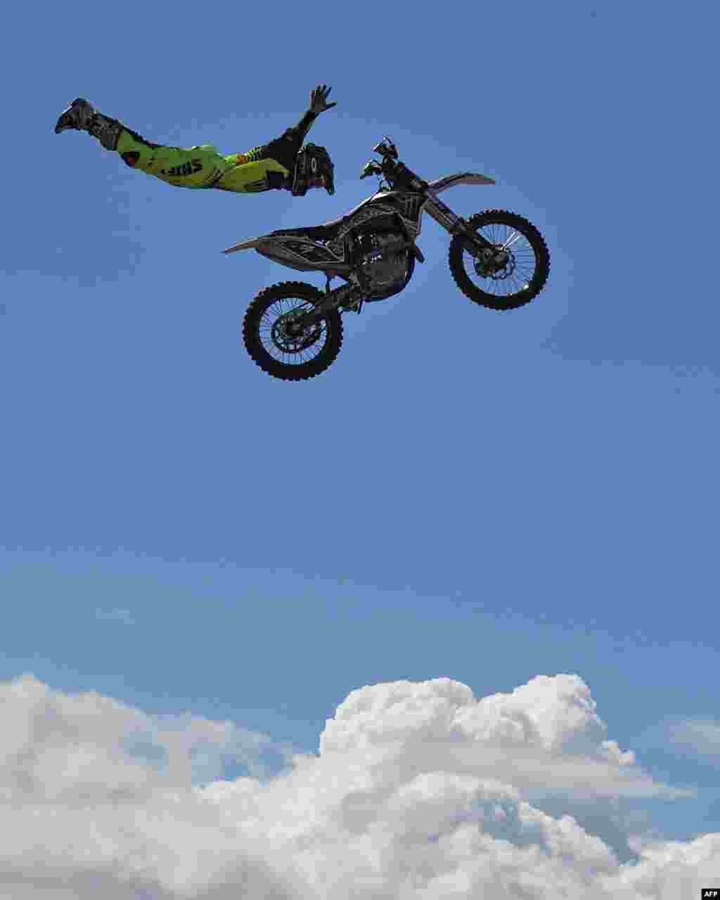 A Nitro Circus member performs above the crowd ahead of the third practice session of the Formula One Australian Grand Prix in Melbourne.