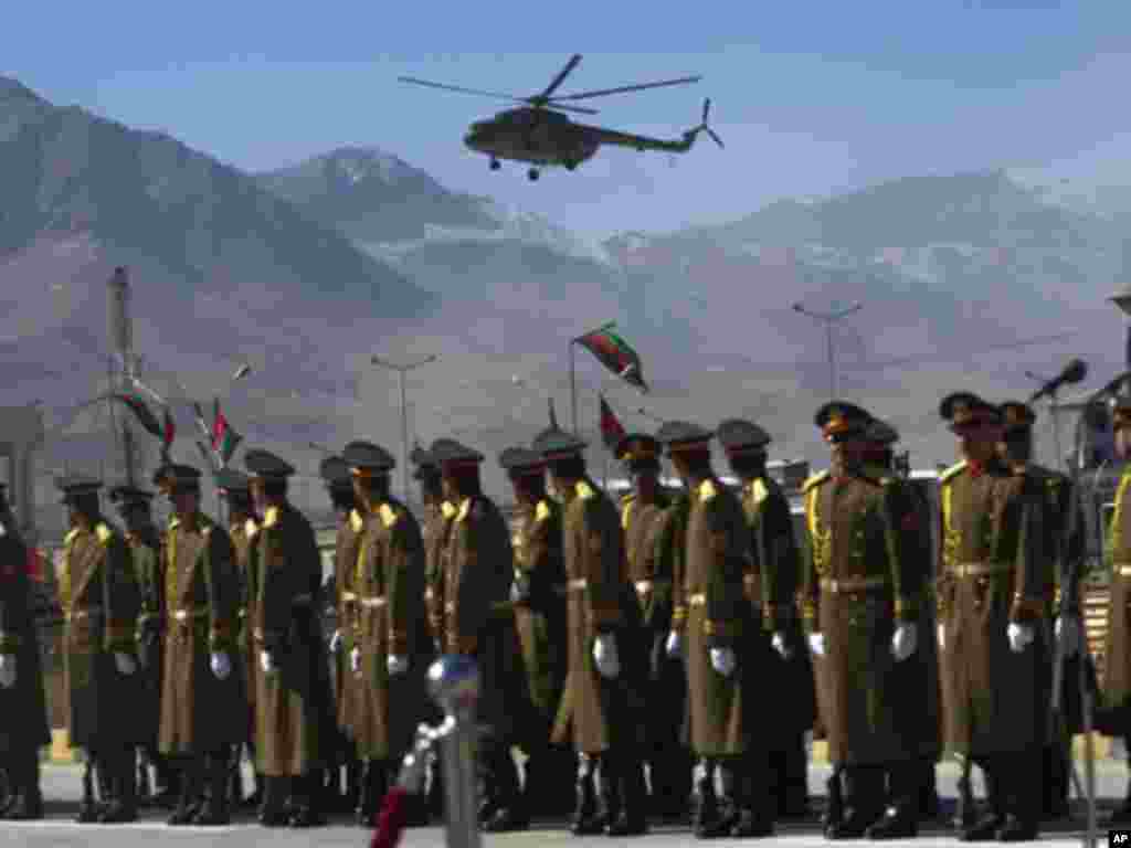 Afghan honor guards watch a helicopter carrying Afghan President Hamid Karzai as he arrives to inaugurate Afghanistan's parliament in Kabul January 26, 2011. Karzai opened parliament on Wednesday, ending a standoff with lawmakers, but setting the stage fo