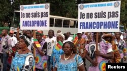 FILE - Demonstrators carry banners as they take part in a march voicing their opposition to independence or more autonomy for the Anglophone regions, in Douala, Cameroon Oct. 1, 2017.