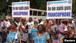 FILE - Demonstrators carry banners as they take part in a march voicing their opposition to independence or more autonomy for the Anglophone regions, in Douala, Cameroon, Oct. 1, 2017.