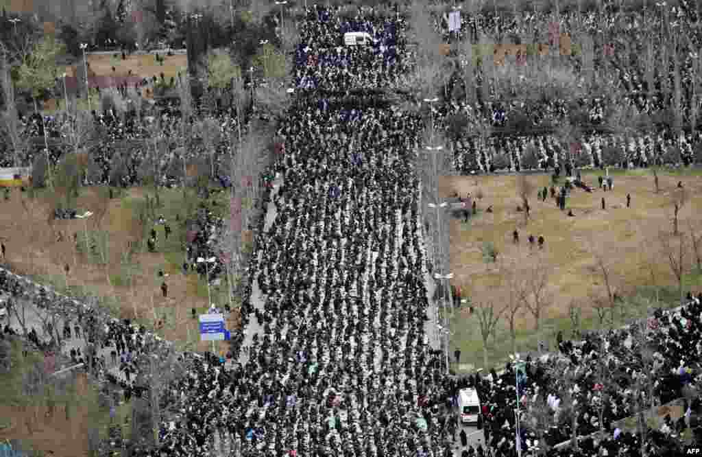Crowds of worshippers follow as Iran&#39;s Supreme Leader Ayatollah Ali Khamenei leads Friday prayers during a ceremony at the capital Tehran&#39;s Grand Mosque, in this handout picture provided by the office of Khamenei. 