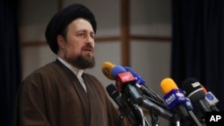 FILE - Hassan Khomeini, grandson of the founder of Iran’s Islamic Republic, Ayatollah Khomeini, speaks in Tehran, Iran, Dec. 18, 2015. Khomeini's bodyguards assaulted a reporter in Tehran, and reporters said such an attack is routine there. 