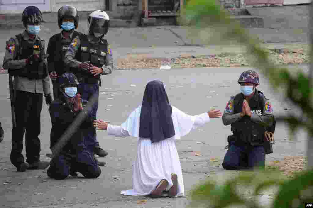 This handout photo by the Myitkyina News Journal shows a nun pleading police not to harm protesters in Myitkyina in Myanmar&#39;s Kachin state, March 8, 2021.