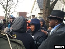 Janet Cooksey, mother of Quintonio Legrier, is consoled by relatives and friends after speaking to the media in Chicago, Illinois, Dec. 27, 2015.