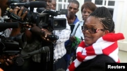 Zimbabwe's Lawyers For Human Rights Board Member Beatrice Mtetwa speaks to the media outside the High Court after she was granted a $500 bail in Harare, March 25, 2013.