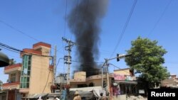 Smoke rises from an area where explosions and gunshots were heard, in Jalalabad city, Afghanistan, July 31, 2018.
