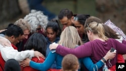 Parents gather in a circle to pray at a recreation center where students were reunited with their parents after a shooting at a suburban Denver middle school, May 7, 2019, in Highlands Ranch, Colo.
