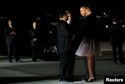 President Barack Obama and first lady Michelle Obama arrive in San Bernardino, California, to meet with the families of victims of a recent mass shooting incident, Dec. 18, 2015.