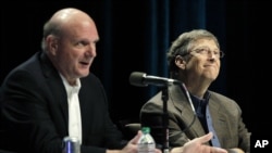 FILE - Then-Microsoft Corp. CEO Steve Ballmer (L) answers a question from a shareholder with Microsoft founder and chairman Bill Gates (R) during Microsoft's annual meeting of shareholders, on Nov. 28, 2012, in Bellevue, Washington.