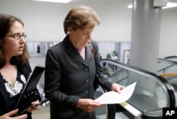 Sen. Jeanne Shaheen, D-N.H., right, arrives with an aide for a vote on Gina Haspel to be CIA director, on Capitol Hill, May 17, 2018 in Washington.