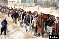 Afghan men carry the coffin of one of the victims of the attack on Kabul, Afghanistan, Jan. 28, 2018. On Saturday, a car bomb ripped through a crowded area outside a government building. Hundreds were killed or wounded.