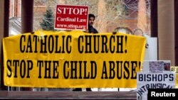 FILE – Demonstrators protest the pedophile priest scandal in Cambridge, Massachusetts, in 2002.