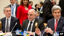 U.S. Secretary of State John Kerry, right, speaks at a meeting in Brussels on fighting the Islamic State, alongside Iraqi Prime Minister Haider al-Abadi, center, and NATO Secretary General Jens Stoltenberg.