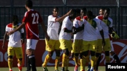 FILE - Guinea's players celebrate scoring a goal against Egypt during their 2014 World Cup qualifying soccer match in Hurghada, Egypt, Sep. 10, 2013.