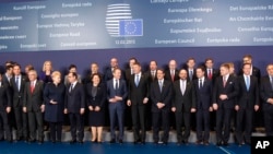 Heads of State and government pose for a group photo at an EU summit in Brussels, Feb. 12, 2015. 