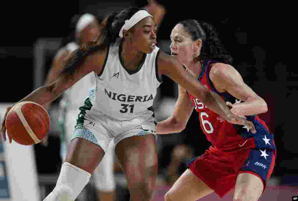 Nigeria&#39;s Erinma Ogwumike (31) drives around United States&#39; Sue Bird (6) during women&#39;s basketball preliminary round game at the 2020 Summer Olympics, Tuesday, July 27, 2021, in Saitama, Japan. (AP Photo/Charlie Neibergall)