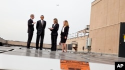 FILE - President Barack Obama tours solar panels on the roof of the Energy Department in Washington, Thursday, March 19, 2015. 